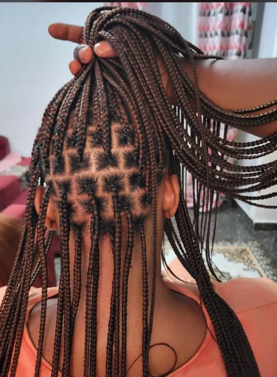 Long medium auburn knotless box braids shown from the back, with crisp square-grid partings clearly visible at the crown